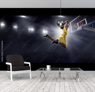 Picture of Basketball player makes slam dunk on big professional arena Player flies through the air with the ball Player wears unbranded clothes